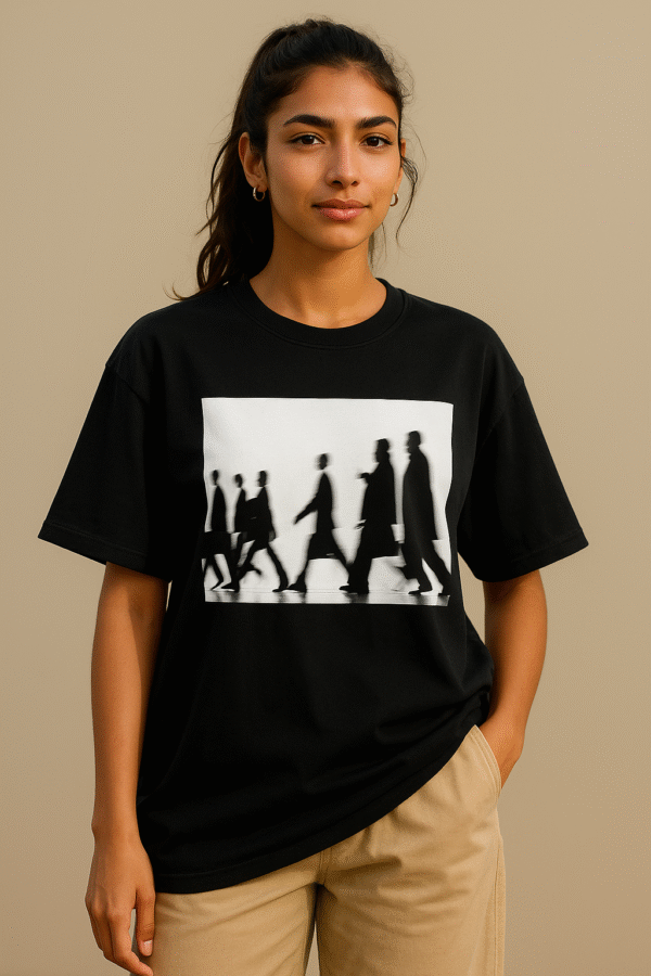 Black oversized t-shirt with grayscale silhouette motion graphic worn by female model – minimalist streetwear style